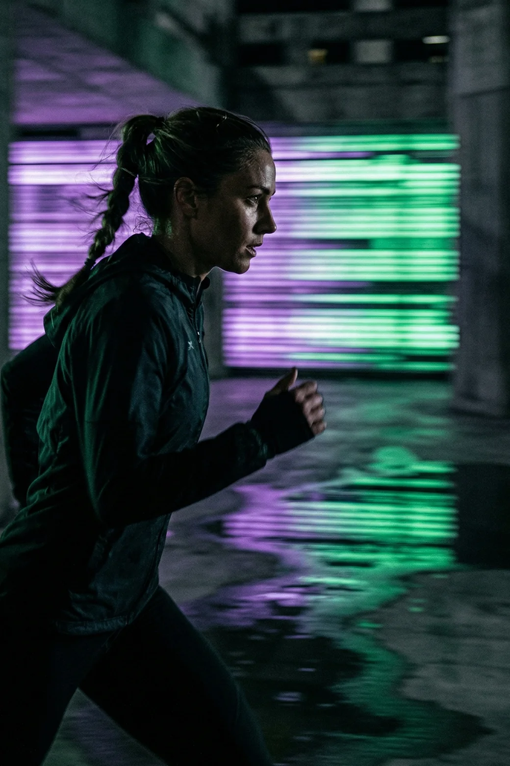 Momentum-Engine-Woman-running-dark-area-motion-blur-lighting-green-purple
